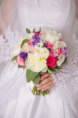 wedding bouquet in hands of the bride