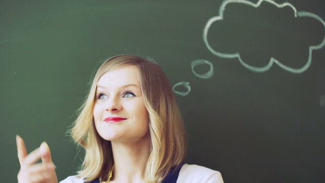 Teacher looking thoughtful and smiling to the camera
