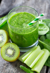fresh green smoothie on wooden surface