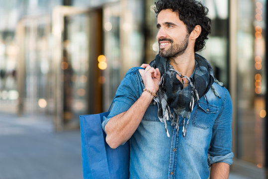 Handsome Man With Shopping Bags Walking Outdoors