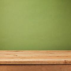 Empty wooden deck table over green wallpaper background. Mock up for product advertise