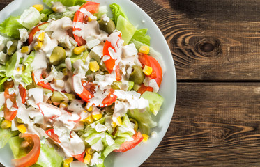 Colorful vegetable salad with tomato and lettuce.