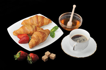 morning Breakfast - croissants with coffee and honey on black ba