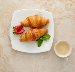 morning Breakfast - croissants with coffee. Strawberries, mint l