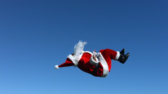 Santa Claus does a flip in the air, slow motion