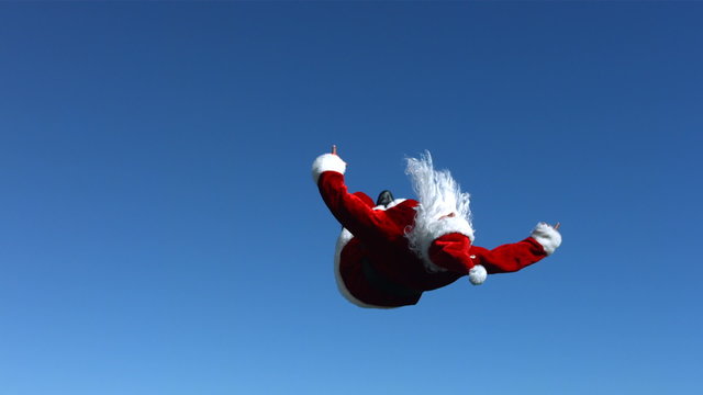 Santa Claus does a flip in the air, slow motion