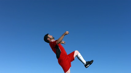 Slow motion of man playing soccer - Powered by Adobe