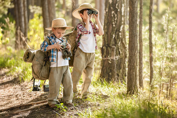 Fototapeta premium Boys on a forest road with backpacks