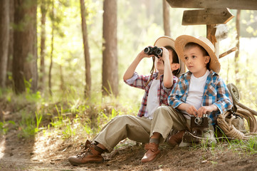 Boys on a forest road with backpacks