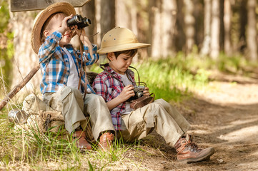Boys on a forest road with backpacks