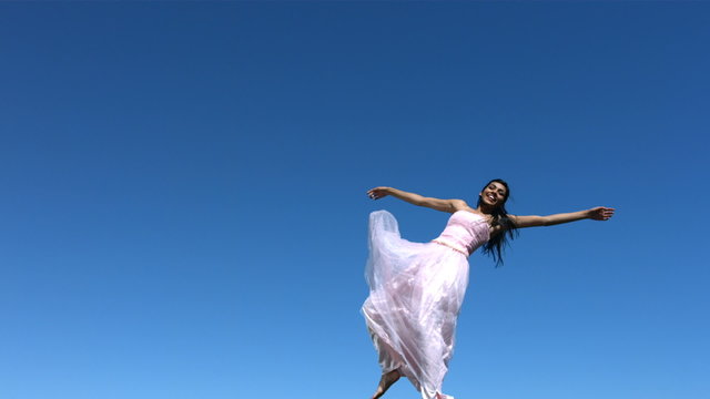 Young woman in dress falls, slow motion