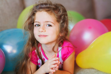 Little girl with multicolored air balloons