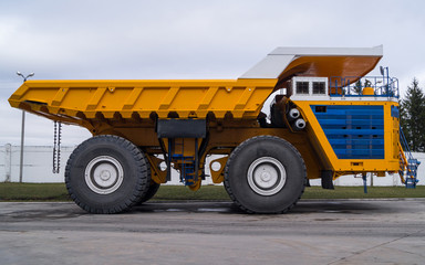Ultra-Class Haul Truck Copy Space Background. Yellow coloring huge mining haul truck.