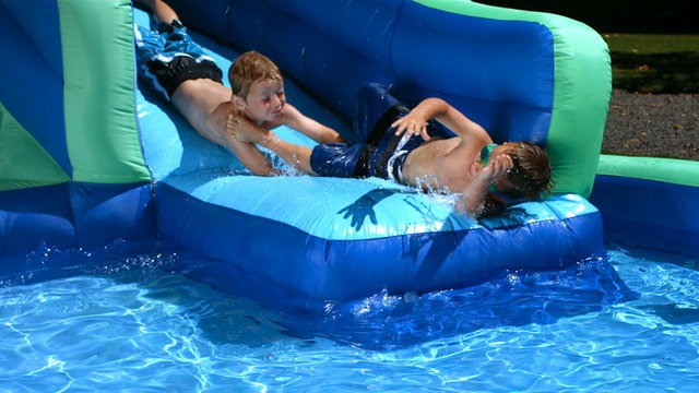 Boys playing on pool slide