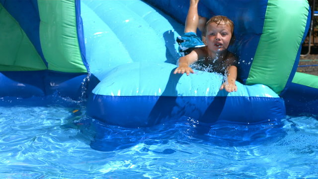 Boy playing on pool slide
