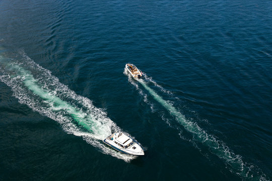 Speed boats aerial view on blue sea.
