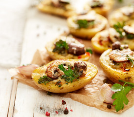 Potato skins loaded with mushrooms, onion, herbs and melted cheese