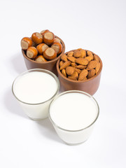 Glass of hazelnut milk and almond isolated on white background.