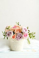 Bouquet of beautiful roses on a blue wooden table