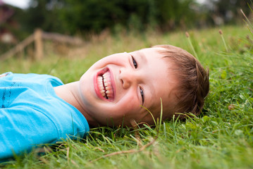 Smiling little boy in the grass