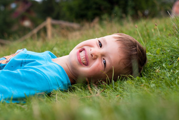 Smiling little boy in the grass