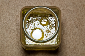 round oil drops in square jar