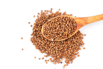 Uncooked buckwheat on wooden spoon