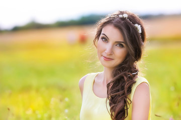 portrait of a pretty girl on the nature in the summer