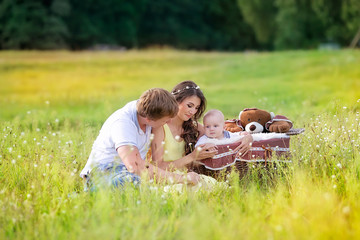 beautiful family with a baby in the park