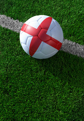 Fototapeta na wymiar Soccer ball and national flag of England, green grass