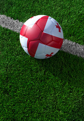 Fototapeta na wymiar Soccer ball and national flag of Georgia, green grass