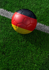 Fototapeta na wymiar Soccer ball and national flag of Germany, green grass