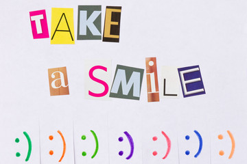 A paper ad with the phrase: Take a Smile and with smile signs. The photo is front.