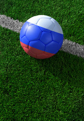 Soccer ball and national flag of Russia,  green grass