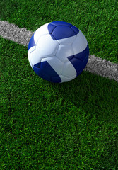 Soccer ball and national flag of Scotland,  green grass