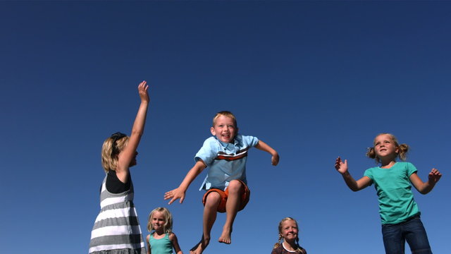 Kids jumping on trampoline, slow motion