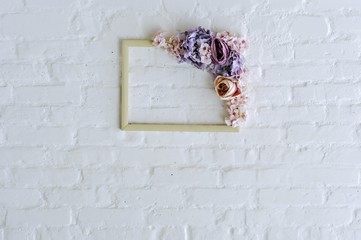 Flower frame on white brick wall