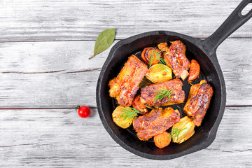 ribs fried in an olive oil in a frying pan