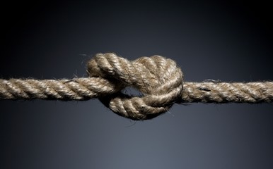 Frayed rope knot on a dark background