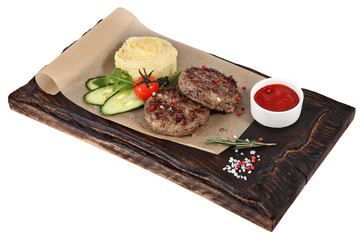 Veal cutlets with mashed potatoes on serving plate dark red.