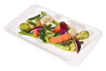 Vegetarian cuisine, steamed vegetables on a long flat white plat