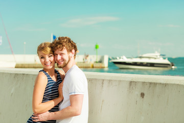 Tourist couple in marina against boats sea water