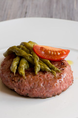 turkey burger with asparagus and tomato.