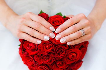 Wedding bouquet and bride's hands