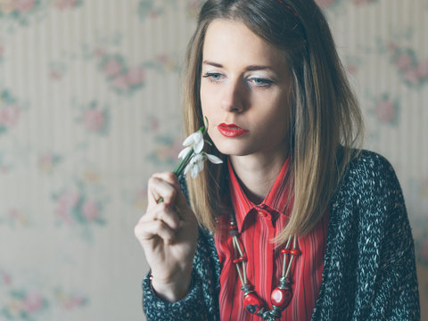 Women smells snowdrop and waiting spring...