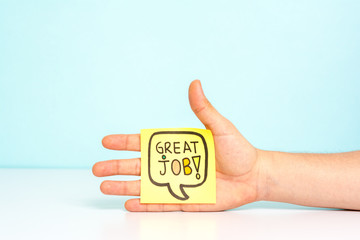 Hand showing a message with great job / well done. Award concept