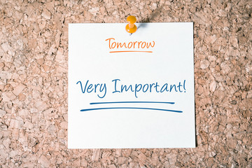 Very Important Reminder For Tomorrow On Paper Pinned On Cork Board