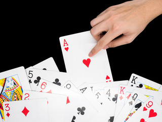Playing cards with hand isolated on black background.