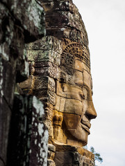 Ancient stone carving face at Bayon Temple in Siem Reap, Cambodia