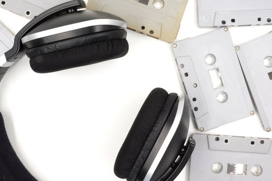 Cassette tapes with headphone on white background.